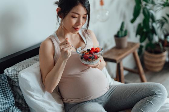 Pregnant woman eating a healthy snack